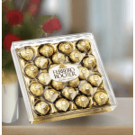 Box of Ferrero Rocher chocolates with red roses in the background