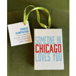 Two hanging mini canvas ornaments with text on a green background