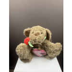 Plush teddy bear holding a red rose