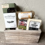 Gift basket with crackers and assorted cheeses in a wooden crate