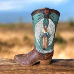 Decorative cowboy boot with an angel figure and cross design