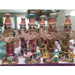 Decorative painted figurines with floral patterns and small garden accessories