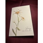 Sympathy card with a pressed flower and the words "Sorry for your loss"