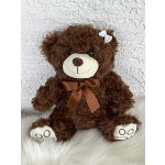 Brown teddy bear with a satin bow and white bow on its ear