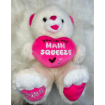 White teddy bear holding a pink heart pillow with text