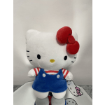Hello Kitty plush toy in blue overalls with a red bow