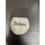Small polished stone engraved with the word "Believe"