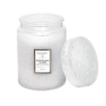 White scented candle in a glass jar with a lid