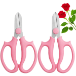 Pink-handled pruning shears beside two red roses