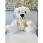 White teddy bear with a pale yellow ribbon