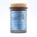 Brown jar candle with a cork lid and blue label