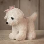White plush poodle with a pink polka-dot bow