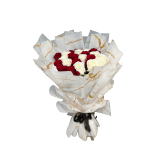 Bouquet of red and white roses wrapped in white paper with gold accents