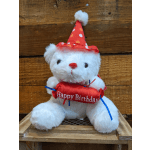 White teddy bear wearing a red birthday hat and holding a Happy Birthday balloon