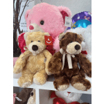Three plush teddy bears displayed with a large pink bear in back