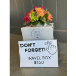 Small mixed flower arrangement in a white travel box with a price sign