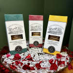 Three boxes of shortbread cookies arranged in a tray with red heart garland.