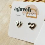 Heart-shaped stud earrings on a branded card