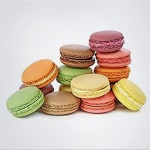 Stack of colorful macarons on a white background