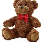 Brown plush teddy bear with tan paws and a red bow sitting upright.
