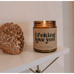 Lit candle in a glass jar beside a decorative ceramic object