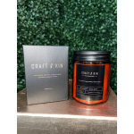 Boxed candle beside an amber glass jar candle labeled Violet Velvet