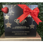 Black Godiva chocolate gift box with hanging star design, red bow, and glitter heart accent