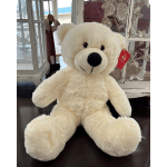 Cream-colored teddy bear sitting on a table