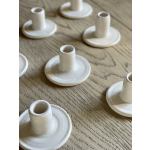 White ceramic candle holders on a wooden table