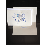 Stacked thank-you greeting cards with blue script on white fronts