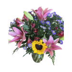 Bouquet of pink lilies, purple daisies, and a sunflower in a glass vase