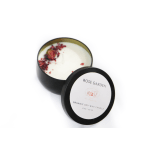 Black tin candle with rose petals on top and a matching lid beside it