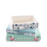 Stack of three decorative book-shaped boxes with floral designs