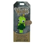 Bright green yarn doll keychain with googly eyes holding a shamrock on branded backing card.