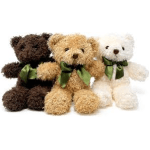 Three teddy bears in brown, tan, and white with green ribbons