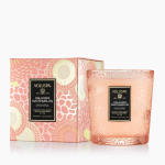 Pink Voluspa candle in a patterned glass jar with matching box