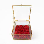 Red roses in a clear gold-framed box with an open lid