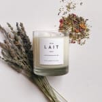 Lavender candle with dried lavender sprigs and loose dried petals