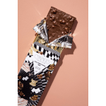 Chocolate bar in patterned wrapper on a pink background