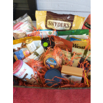 Basket of assorted snack packages and candy with shredded paper filler