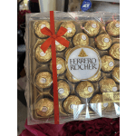 Box of Ferrero Rocher chocolates tied with a red ribbon
