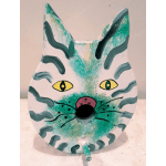 Painted cat face on a white oval object with teal accents