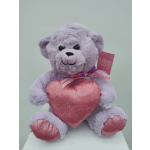 Lavender teddy bear holding a pink heart pillow