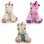 Three plush unicorn toys in pastel colors on a white background.