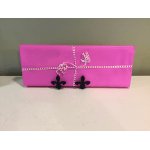 Pink gift box wrapped with heart-pattern ribbon and black fleur-de-lis decorations