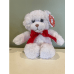 White teddy bear with a red ribbon bow