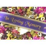 Purple memorial ribbon over a colorful floral arrangement