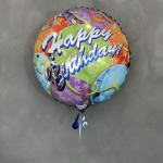 Round birthday balloon with colorful confetti design and ribbon tail