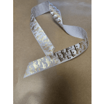 White ribbon with gold Dior lettering on brown paper