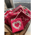Basket of red and pink knitted heart ornaments